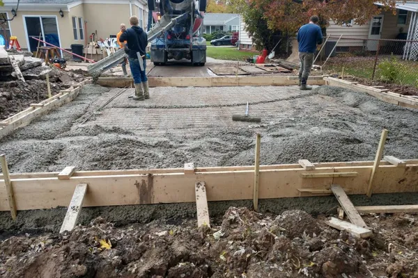 Concrete crew actively pouring and finishing a driveway in Murrieta